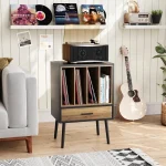 Vinyl record storage cabinet with records and a turntable in a stylish living room setting